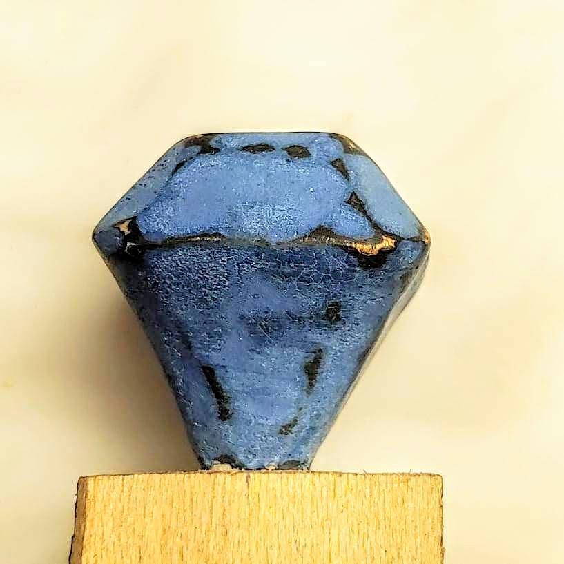 blue carved wooden gem