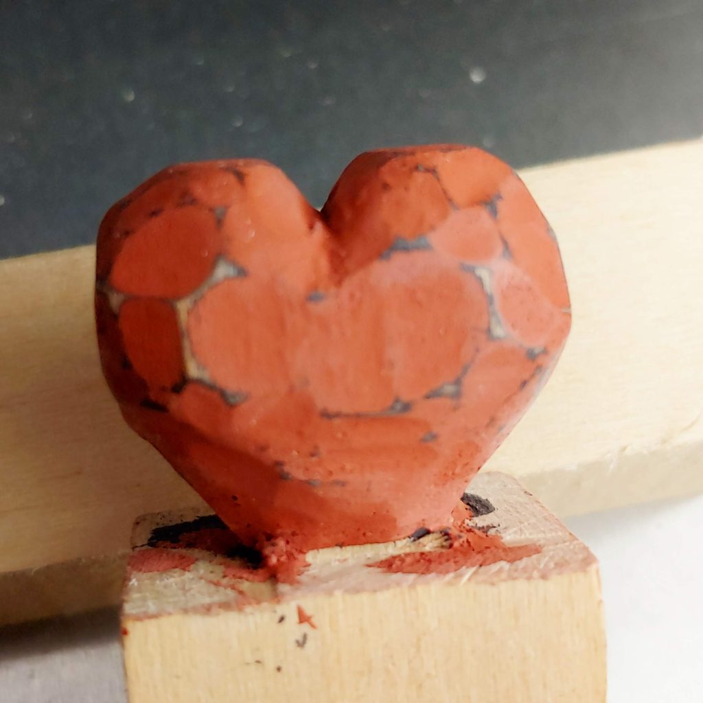 red heart carved in wood