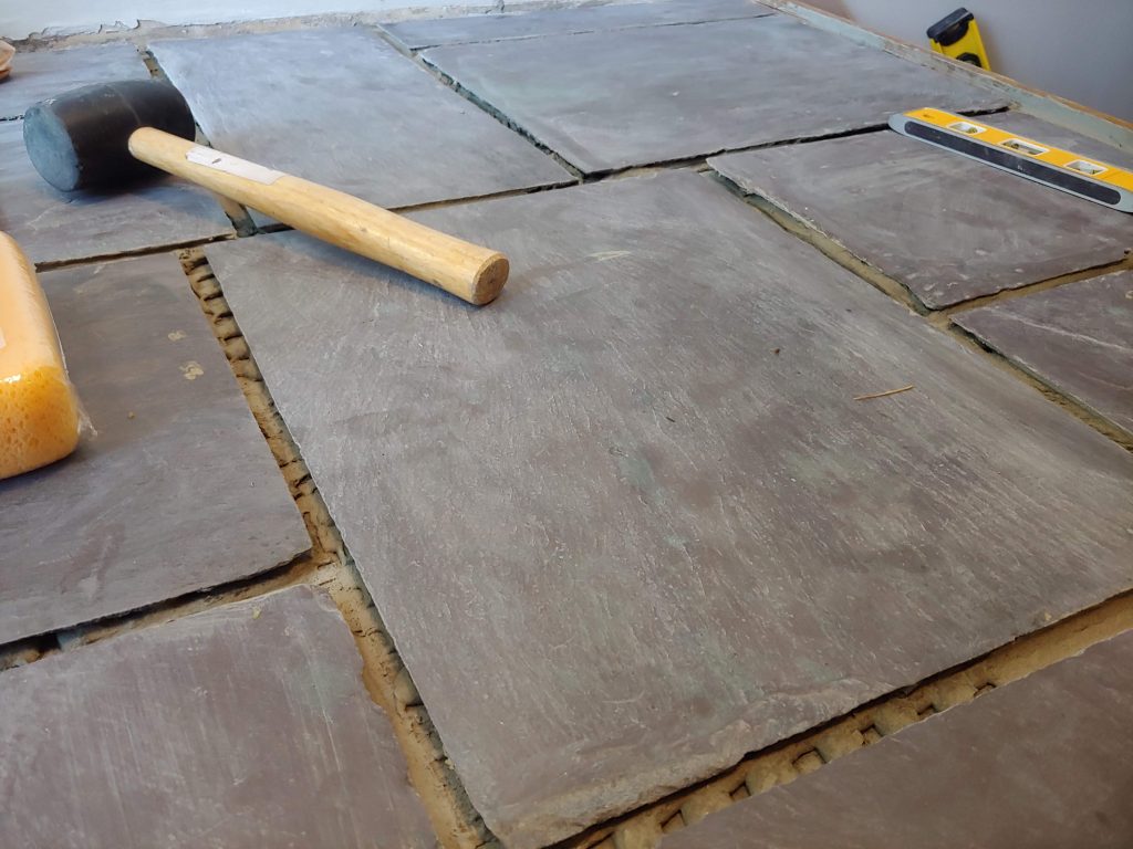 rubber mallet on unfinished slate floor